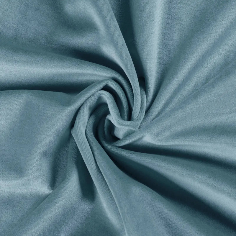 Photograph of soft light blue teal velvet fabric draped in a swirling spiral pattern showcasing plush folds and subtle highlights