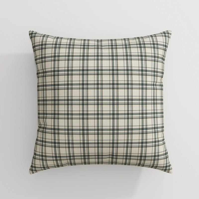 A square throw pillow with a plaid pattern featuring dark green, light green, black, and beige lines against a white background