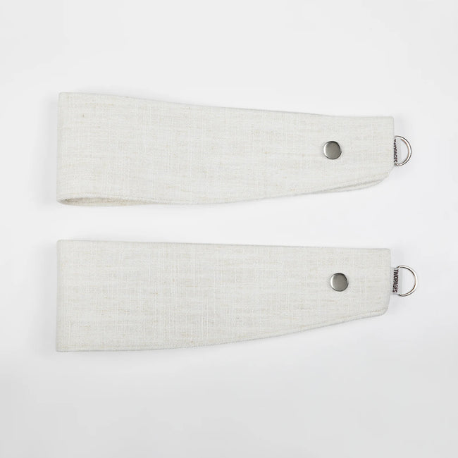 Product Photo two light beige linen-look fabric curtain tie-backs on a plain white background each featuring a silver-toned metal grommet and a "TWOPAGES" branded D-ring at the tapered end